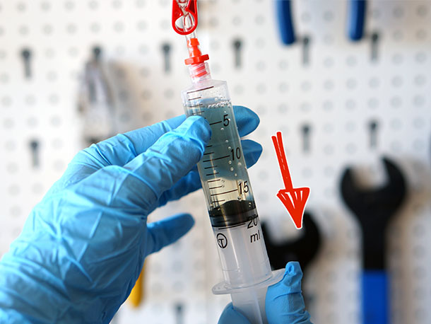 Degassing brake fluid in syringe during brake bleeding