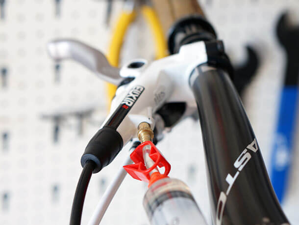 Bleed syringe attached to Avid Elixir R disc brake lever bleed port