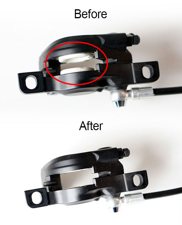 Shimano Deore brake calliper with pistons reset. Before and after